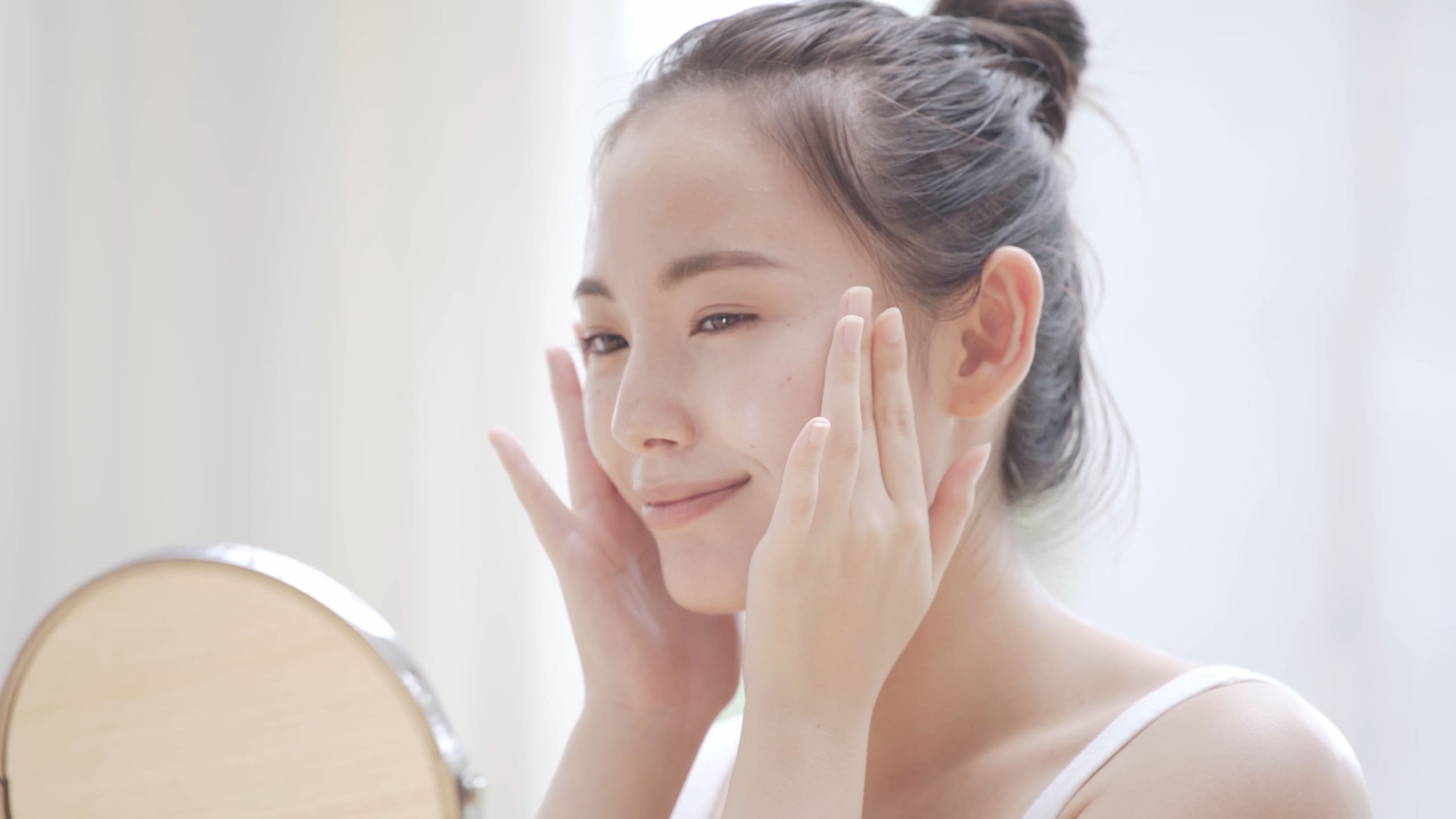 スキンケアする女性(AdobeStock_377693426)