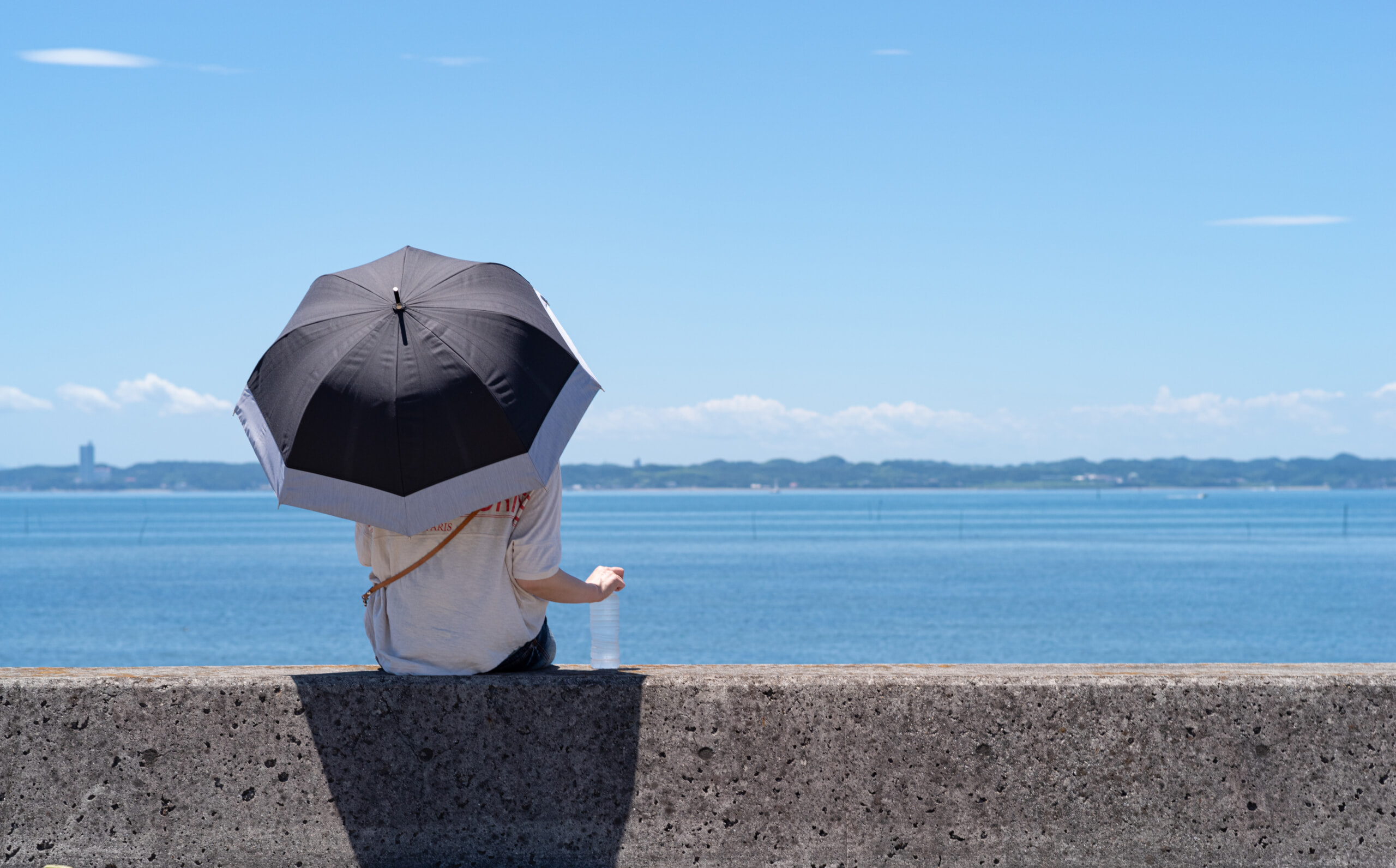 堤防に座る女性